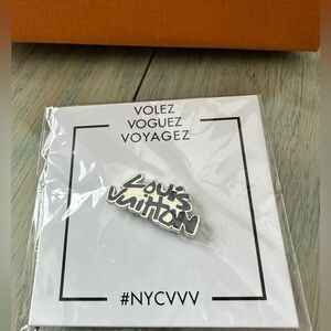 Louis Vuitton volez voguez voyagez exhibit pin